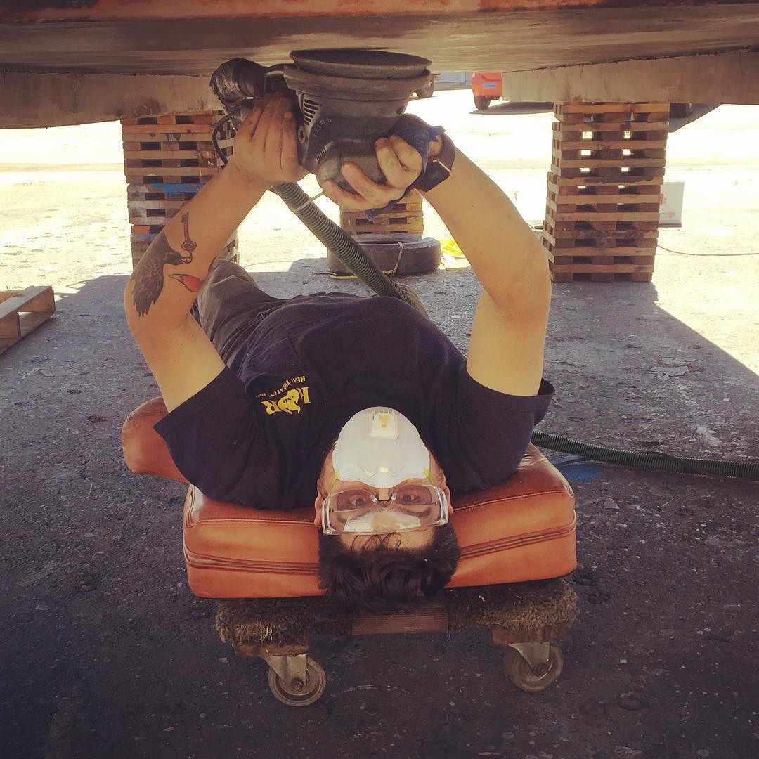 Sanding the hull of the #shantyboat in preparation for new bottom paint.