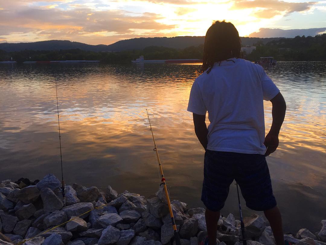 T fishing with his family down by the river