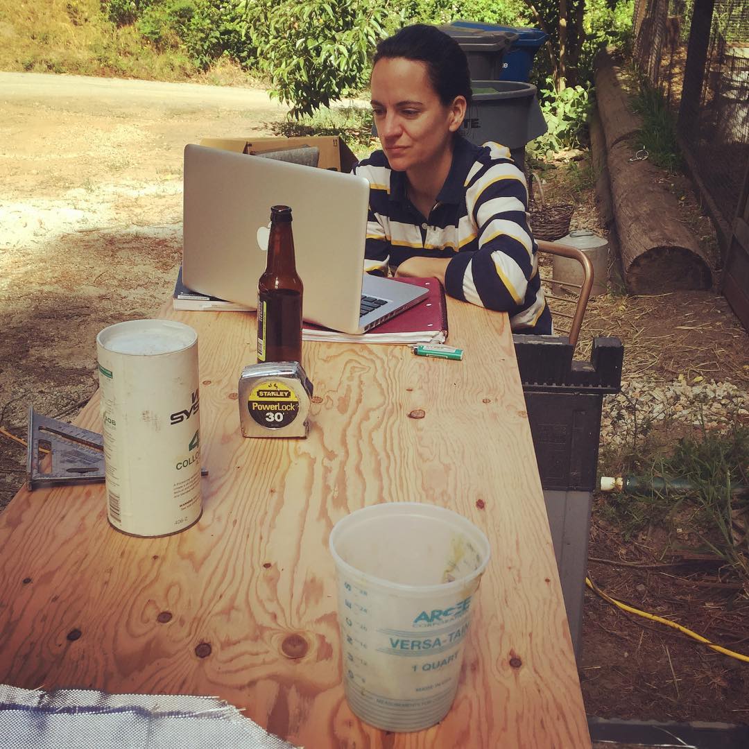 Benzy works on her thesis among the chaos of shantyboat work