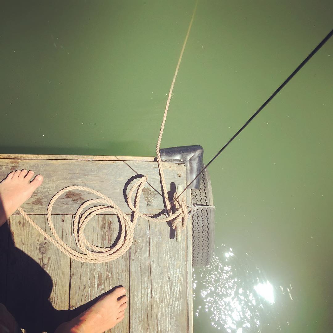 Anchor line set disappearing into the green depths while we fish from the stern