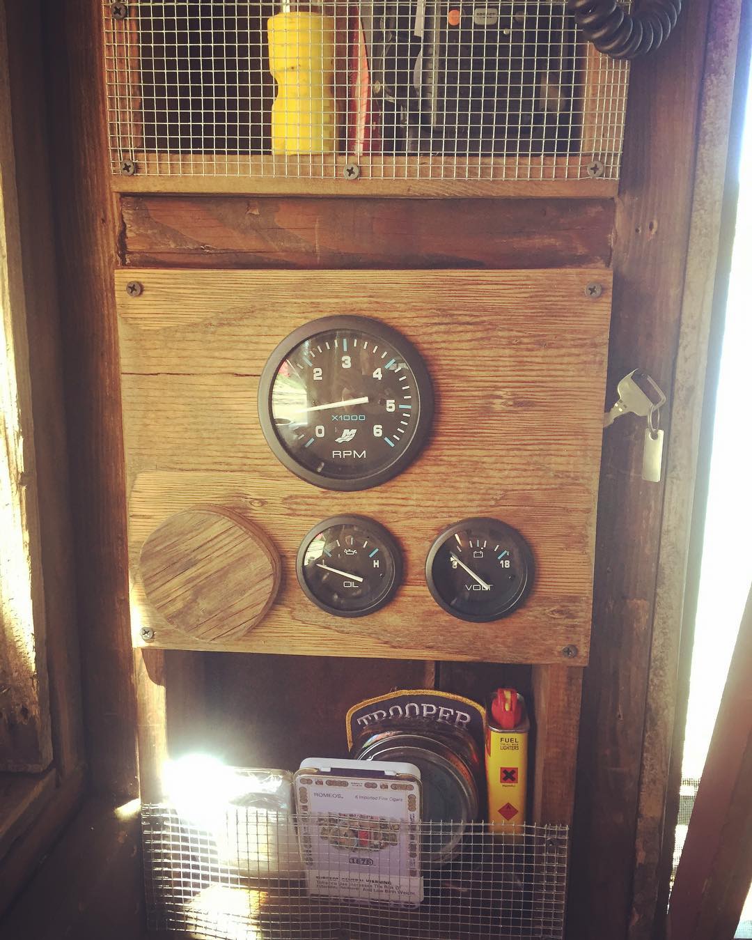 Radio shelf, engine gauges, and tobacco shelf from top to bottom on the shantyboat