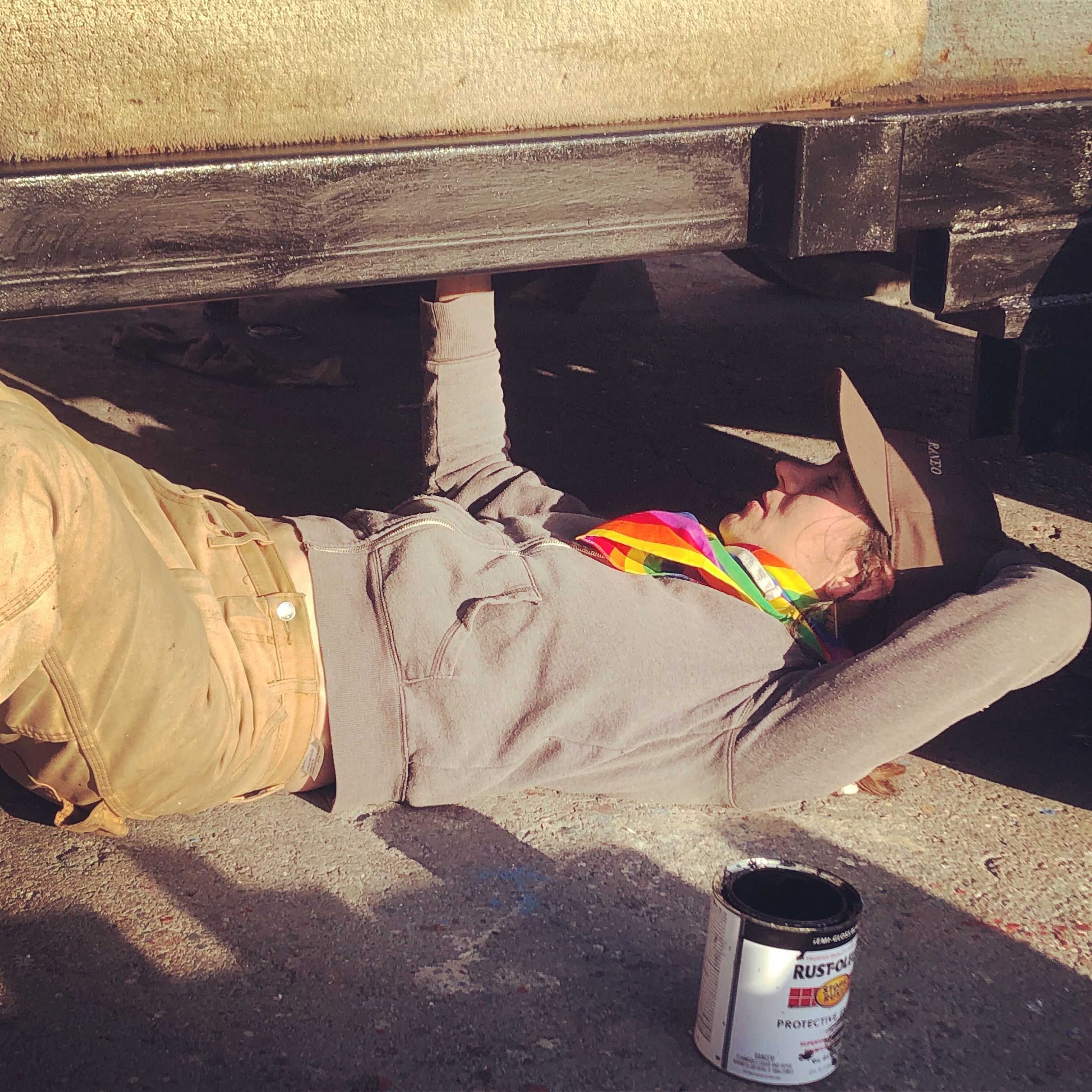 Benzy paints the underside of the shantyboat trailer.